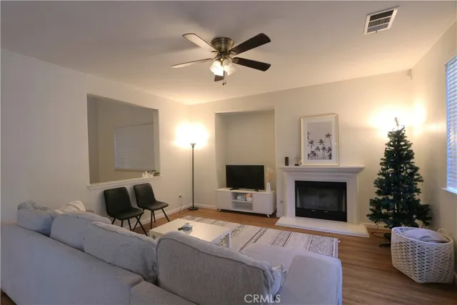 a living room with furniture a fireplace and a flat screen tv