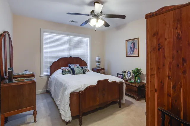 a bathroom with a granite countertop sink a toilet and a mirror