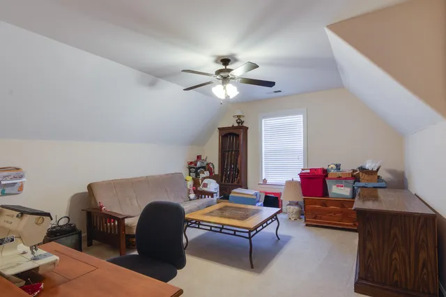 a view of a workspace with furniture and a window
