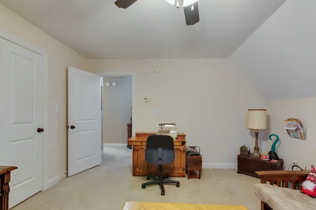 a bedroom with a bed and a chair