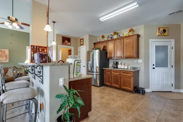 a living room with kitchen island furniture and a kitchen area