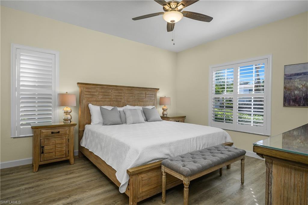 864 Tanbark Drive, Unit 101 Naples, FL 34108 - Photo 19 of 40 a bedroom with a bed and a table