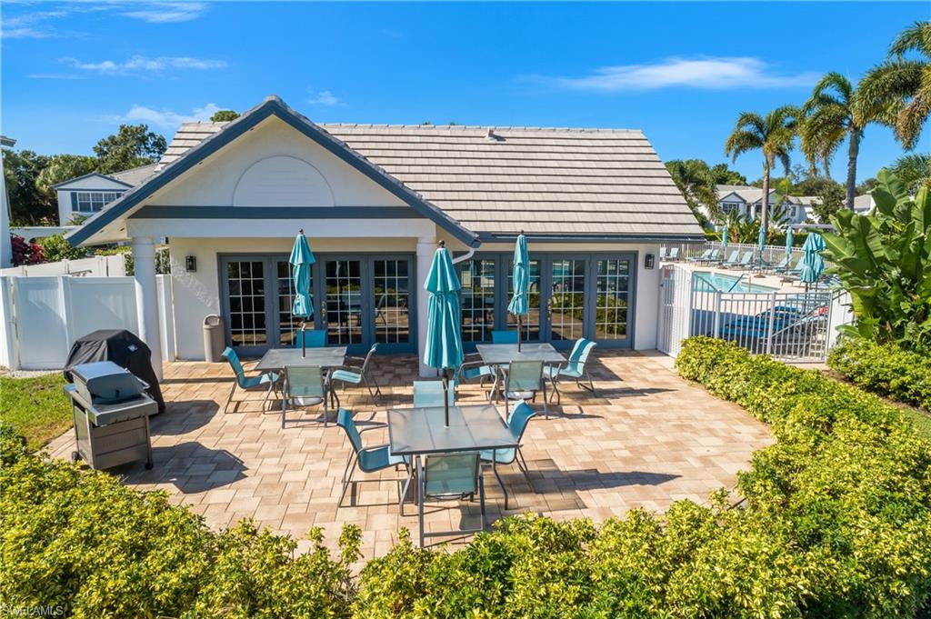 864 Tanbark Drive, Unit 101 Naples, FL 34108 - Photo 36 of 40 a view of a house with backyard and sitting area