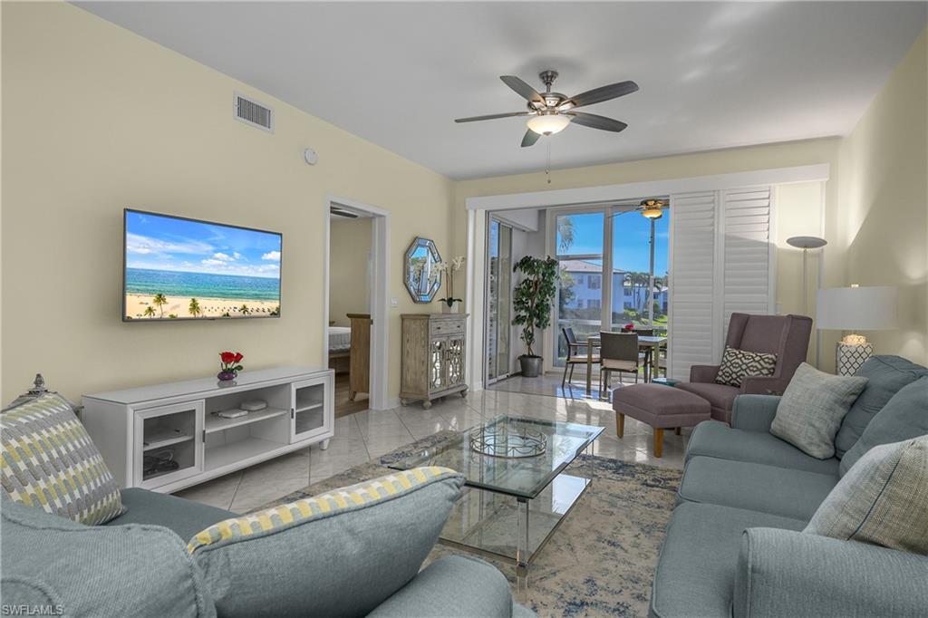 864 Tanbark Drive, Unit 101 Naples, FL 34108 - Photo 7 of 40 a living room with furniture and a ceiling fan