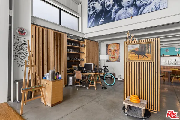 a living room with furniture and a ceiling fan