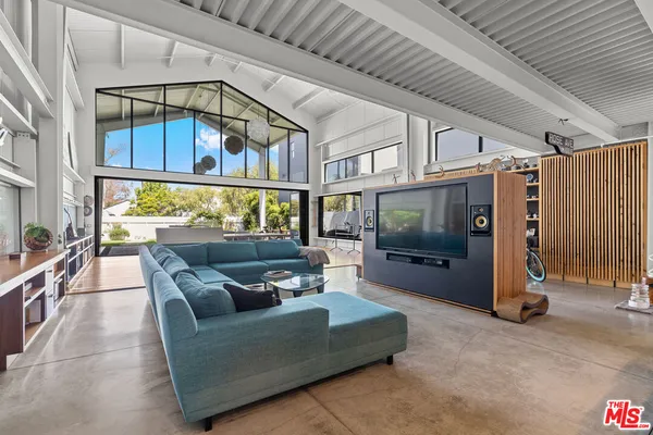 a view of a dining hall with furniture and window
