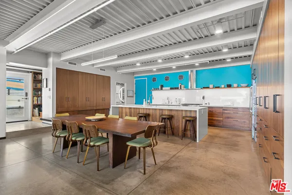 a dinning table and chairs in a kitchen