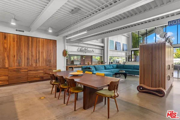 a view of a dining room with furniture and a chandelier