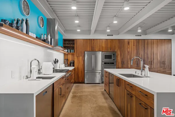 a kitchen with a wooden table and chairs
