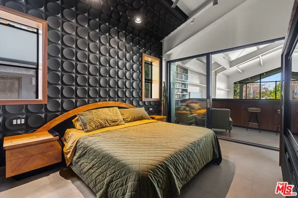 a bedroom with double bed and a window