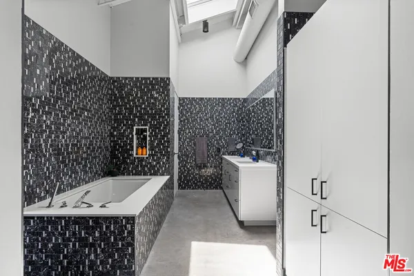 a bathroom with a sink a mirror and shower