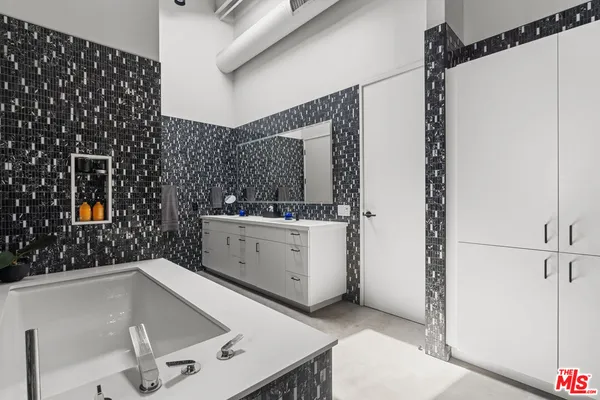 a bathroom with a bathtub and shower