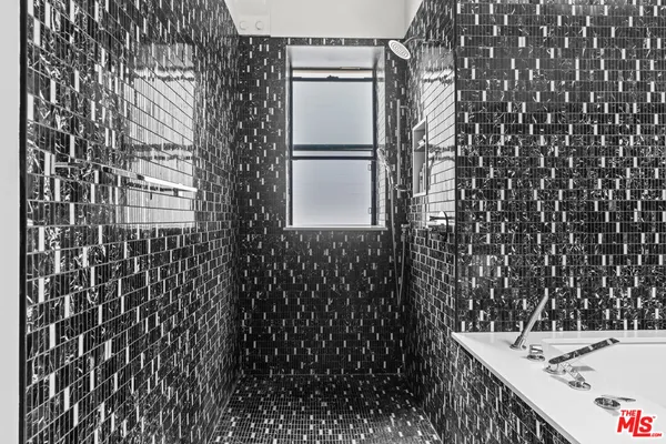 a bathroom with a bathtub and shower