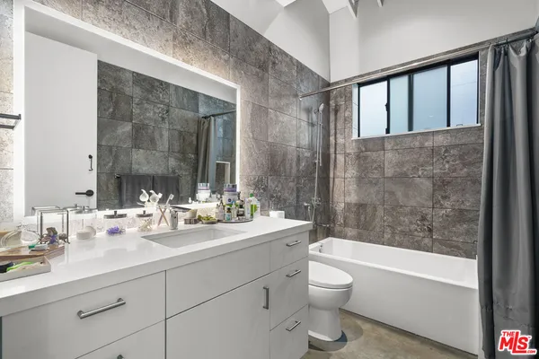 a bedroom with a bed and a desk