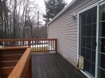 46 Madden Road, Unit 38 West Brookfield, MA 01585 - Photo 12 of 37 a balcony with wooden floor