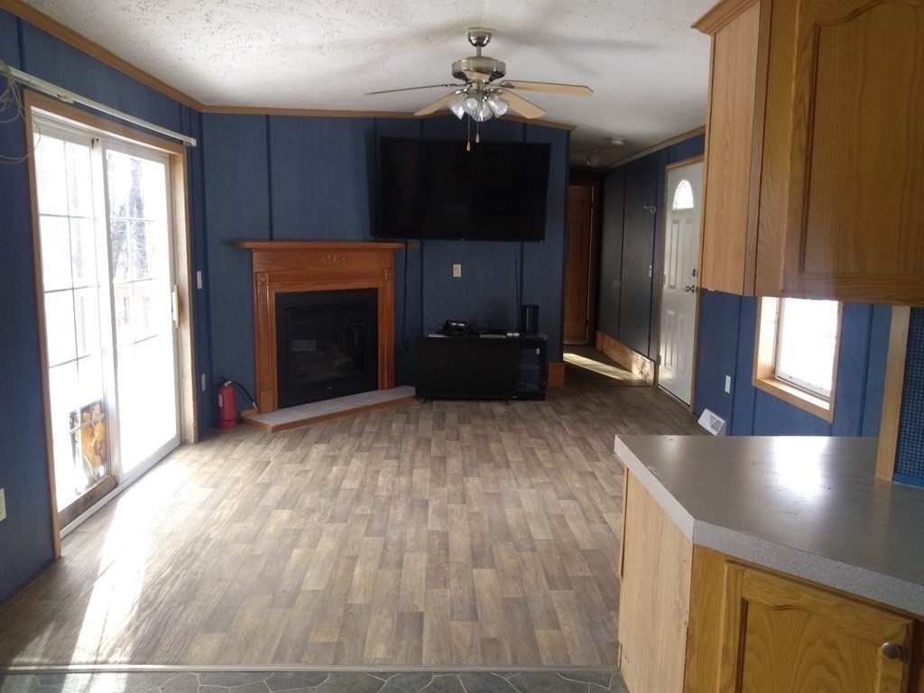 46 Madden Road, Unit 38 West Brookfield, MA 01585 - Photo 15 of 37 a view of a livingroom with an empty space and a fireplace