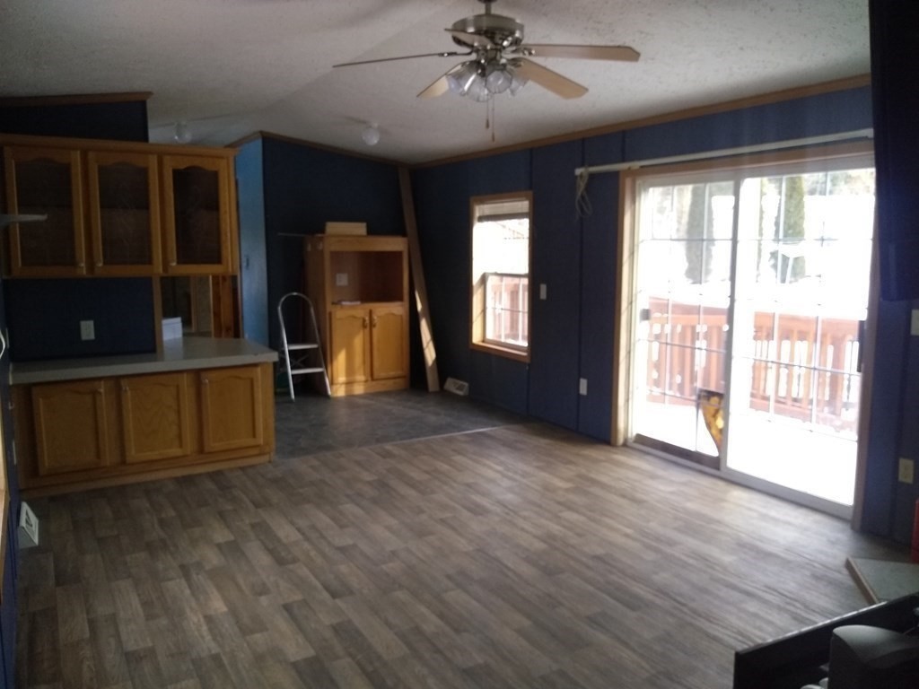 46 Madden Road, Unit 38 West Brookfield, MA 01585 - Photo 16 of 37 a view of an empty room with a window and wooden floor