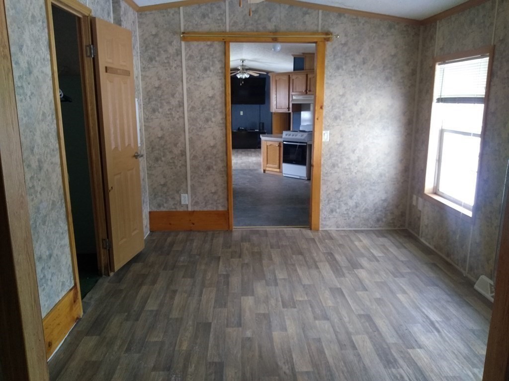 46 Madden Road, Unit 38 West Brookfield, MA 01585 - Photo 22 of 37 an empty room with wooden floor and windows