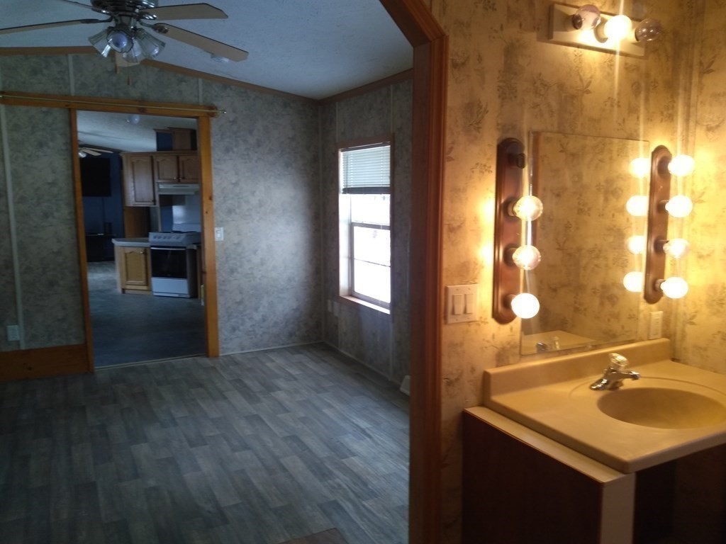 46 Madden Road, Unit 38 West Brookfield, MA 01585 - Photo 24 of 37 a bathroom with a sink and a mirror