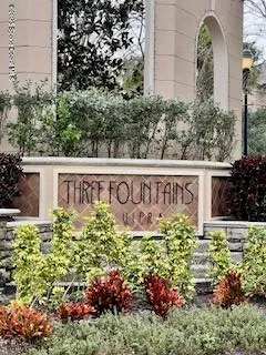 a view of sign board with plants