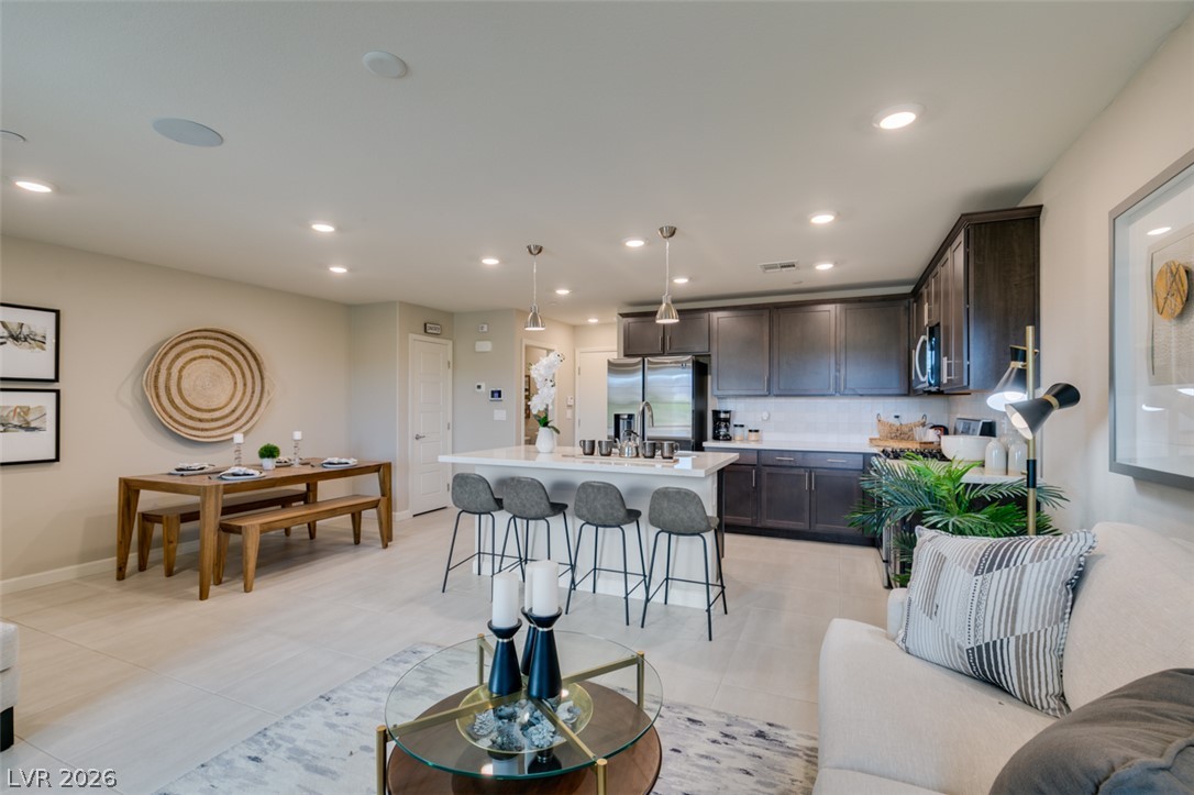 653 Pickled Pepper Place Henderson, NV 89011 - Photo 35 of 35 An open floorplan seamlessly connects the well-lit kitchen and dining areas.