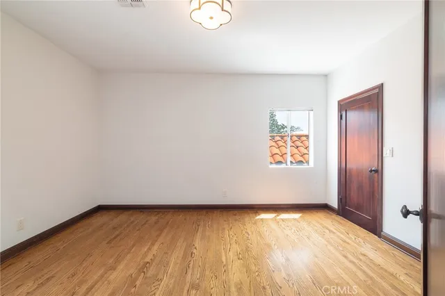 a view of an empty room and wooden floor