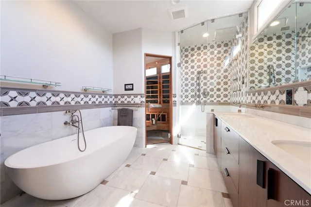 a spacious bathroom with a tub sink and mirror