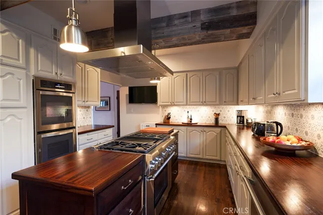 a kitchen with granite countertop a stove and a refrigerator