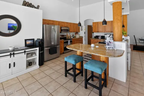 a kitchen with sink refrigerator and stove