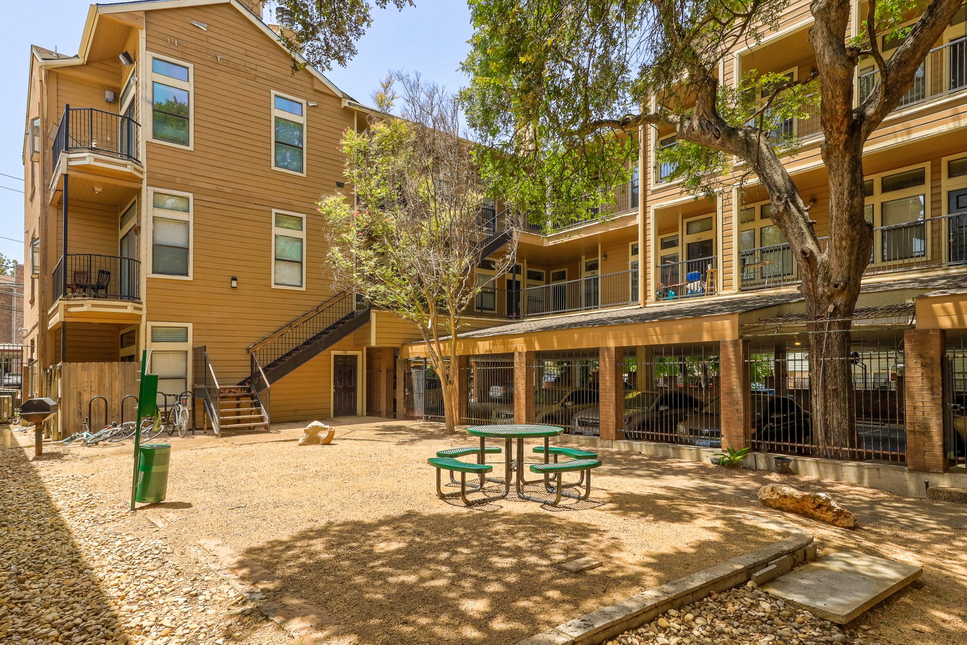 2802 Nueces Street, Unit 306 Austin, TX 78705 - Photo 19 of 20 Central courtyard featuring a picnic table, grill station, and gravel ground cover