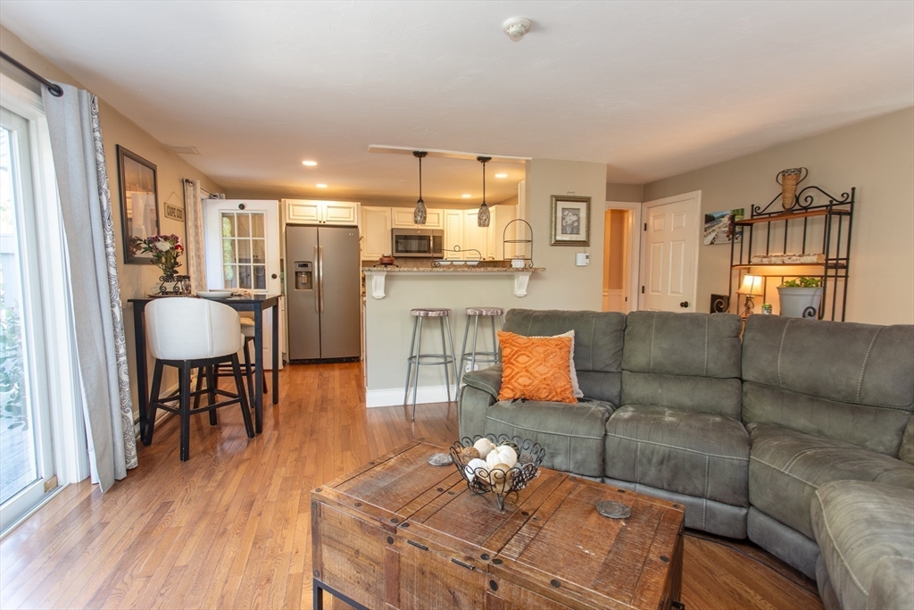 11 Village Green Road, Unit B Bourne, MA 02562 - Photo 12 of 23 a living room with furniture and a table