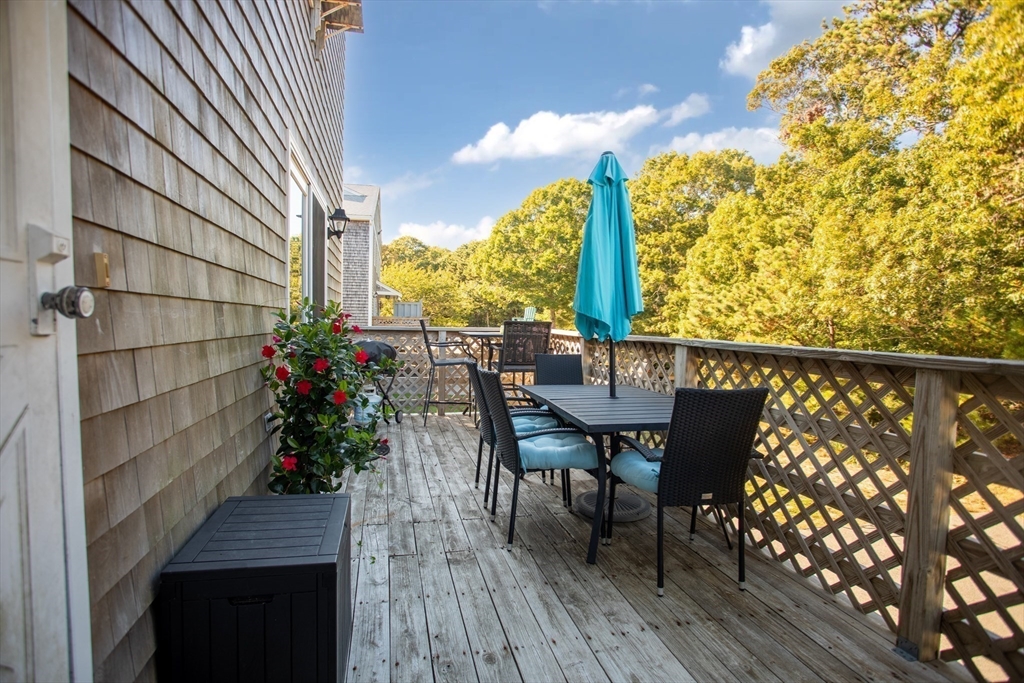 11 Village Green Road, Unit B Bourne, MA 02562 - Photo 5 of 23 a view of a chairs and table on the deck