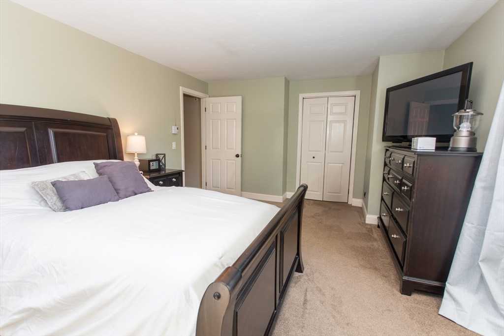 11 Village Green Road, Unit B Bourne, MA 02562 - Photo 7 of 23 a bedroom with a bed and a couch