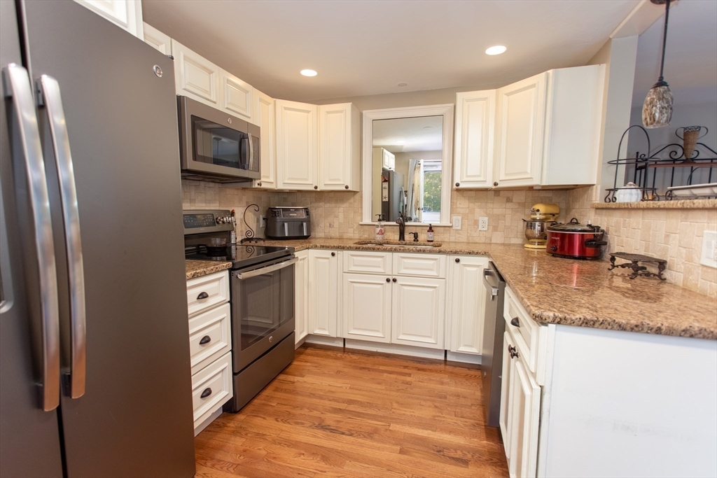 11 Village Green Road, Unit B Bourne, MA 02562 - Photo 10 of 23 a kitchen with a sink white cabinets and stainless steel appliances