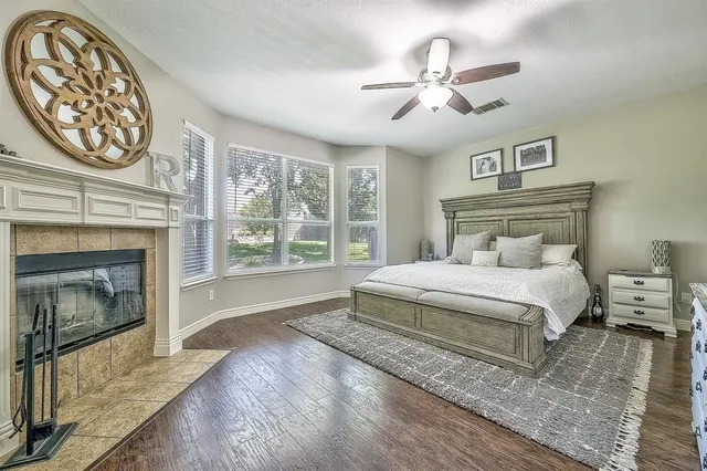 a kitchen with stainless steel appliances granite countertop wooden floor window and cabinets