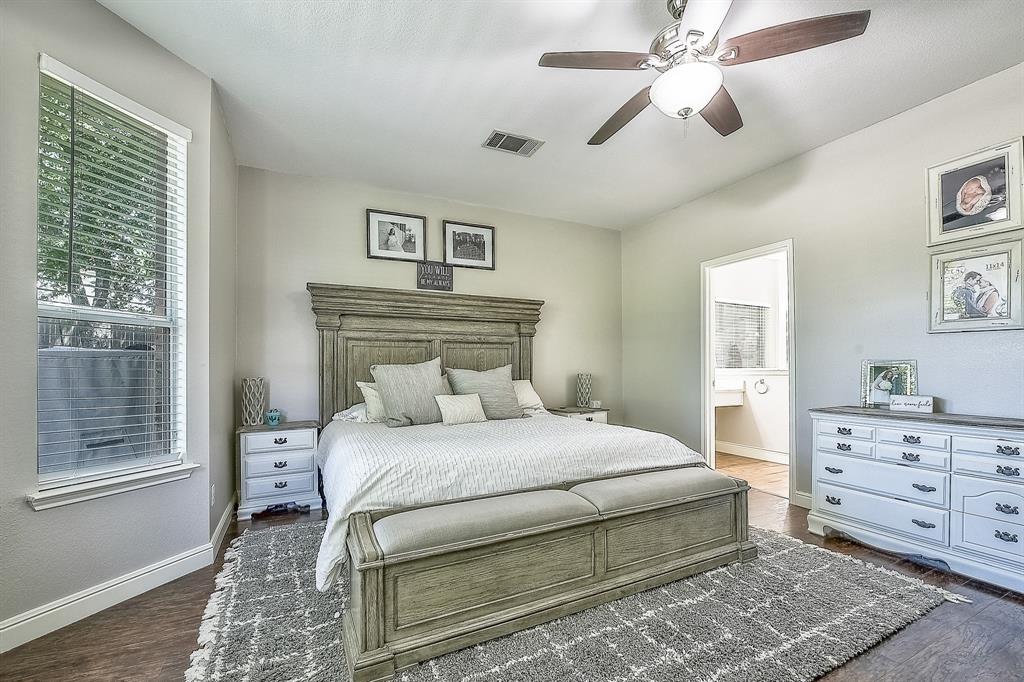 1109 Brandy Court Midlothian, TX 76065 - Photo 11 of 26 Bedroom featuring dark wood-style floors, a ceiling fan, and connected bathroom