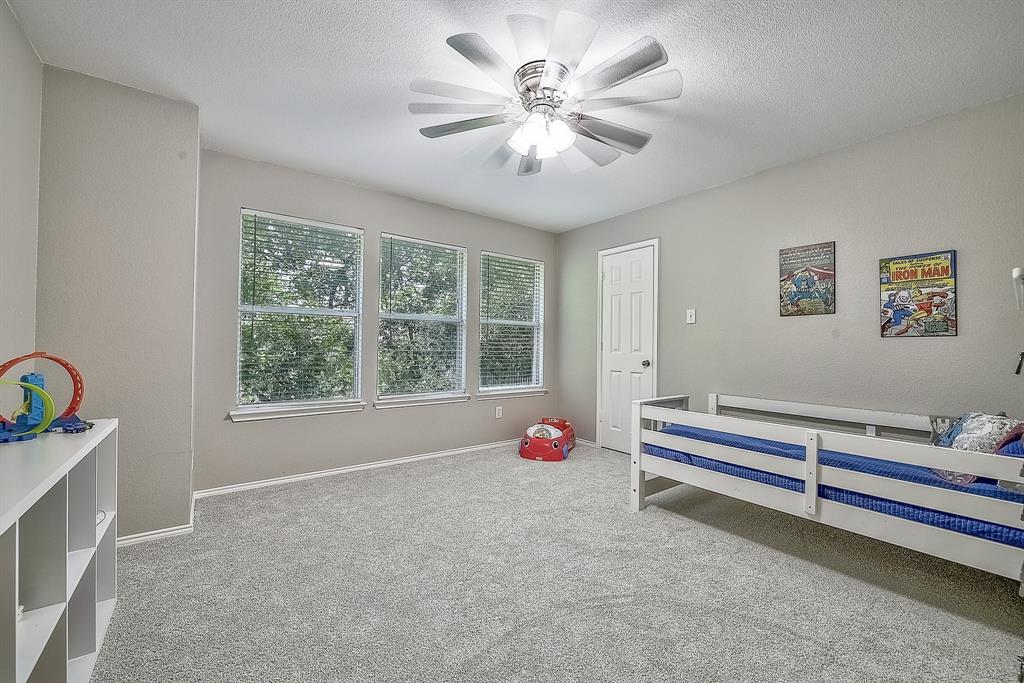 1109 Brandy Court Midlothian, TX 76065 - Photo 14 of 26 Bedroom with light carpet, ceiling fan, and a textured ceiling