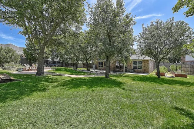 a view of a house with a backyard