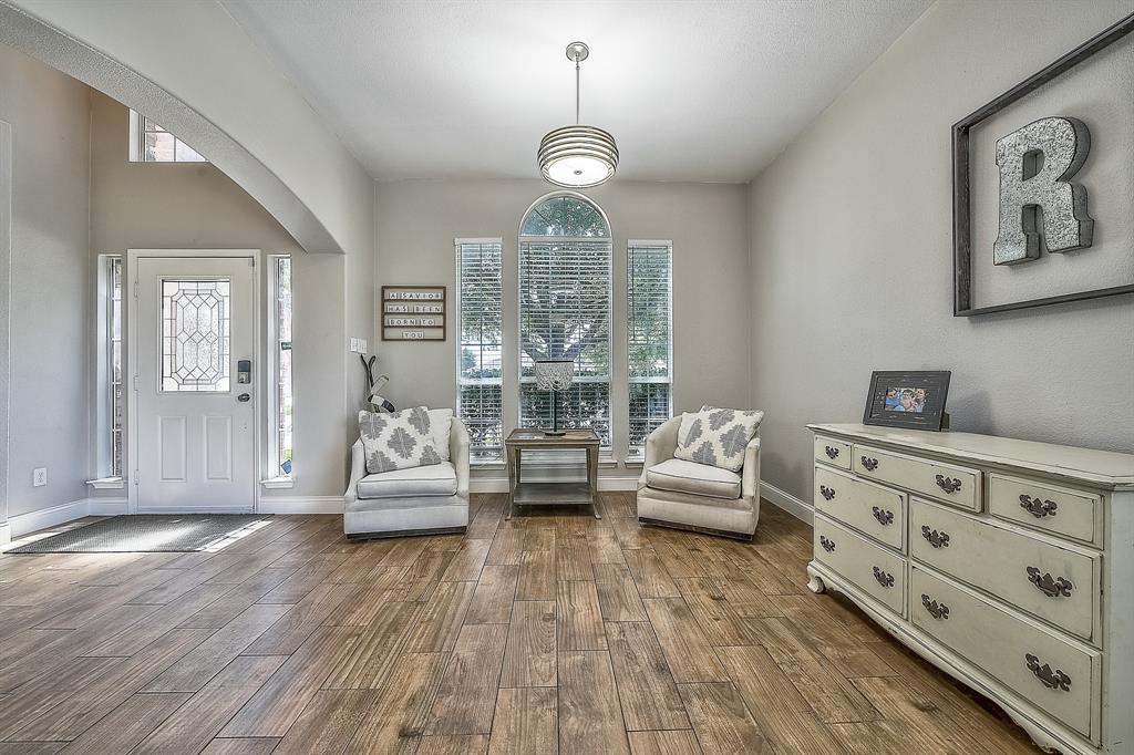 1109 Brandy Court Midlothian, TX 76065 - Photo 3 of 26 Living area featuring plenty of natural light, arched walkways, and dark wood-style floors