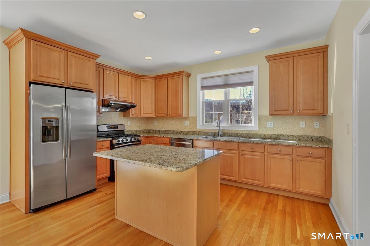 25 Fenwick Drive Avon, CT 06001 - Photo 9 of 40 a kitchen with stainless steel appliances granite countertop a refrigerator sink and cabinets