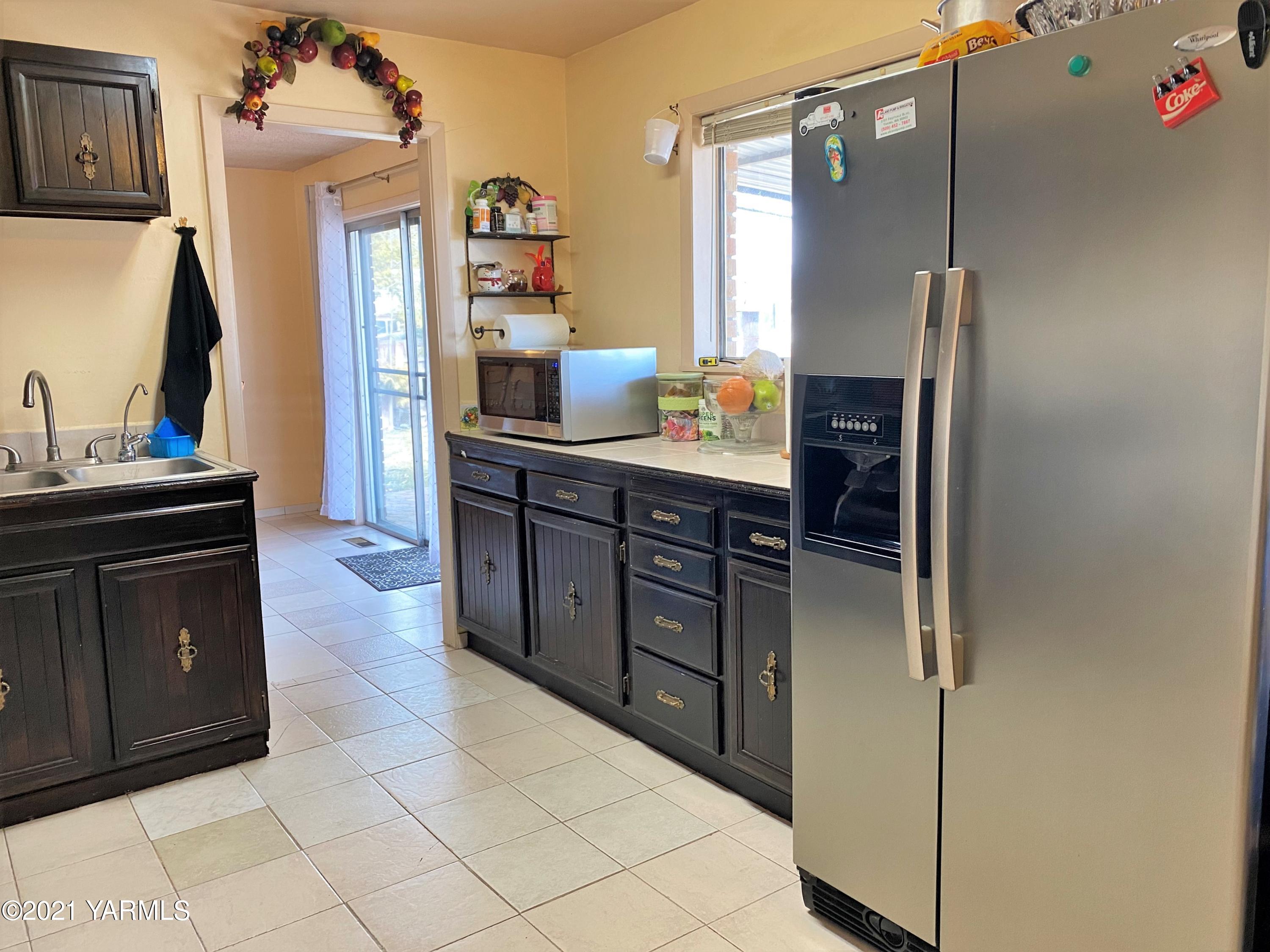 2811 Birchfield Road Yakima, WA 98901 - Photo 14 of 24 a kitchen with kitchen island cabinets and refrigerator