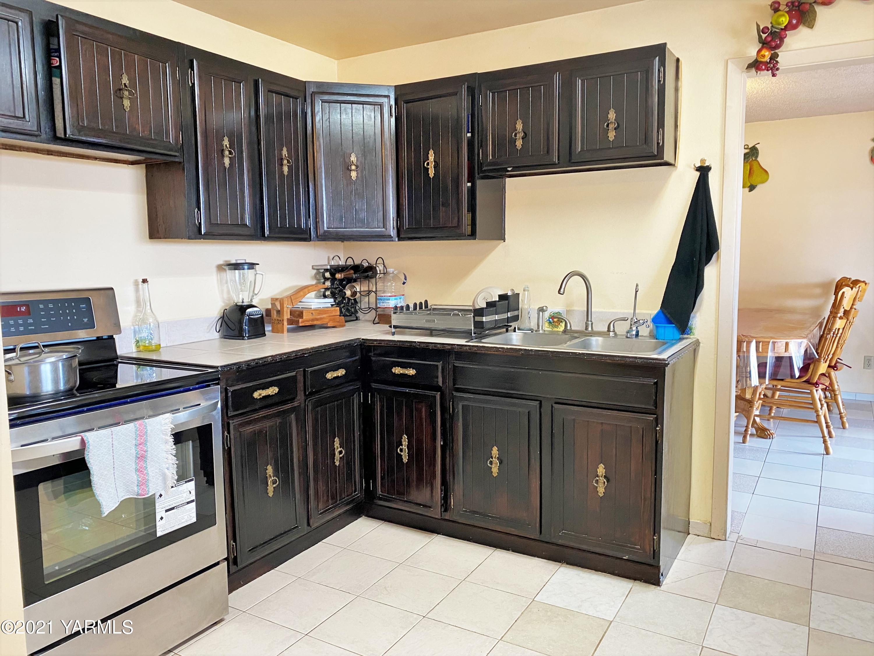 2811 Birchfield Road Yakima, WA 98901 - Photo 15 of 24 a kitchen with stainless steel appliances granite countertop a sink and cabinets