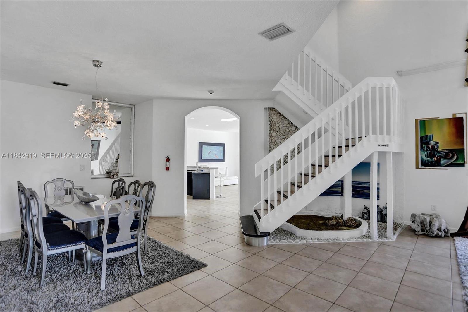 721 Ranch Road Weston, FL 33326 - Photo 34 of 38 a view of a dining room with furniture and a chandelier
