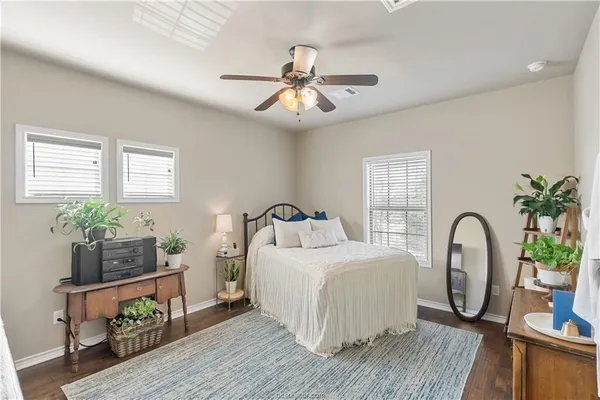a bedroom with bed and a chandelier