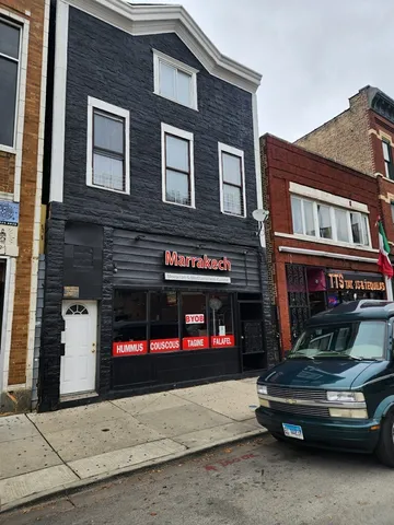 a car parked in front of a brick building