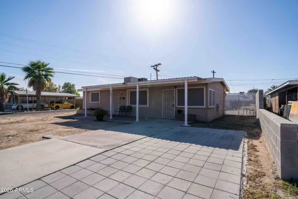 a view of a house with parking space and a car parked in a yard