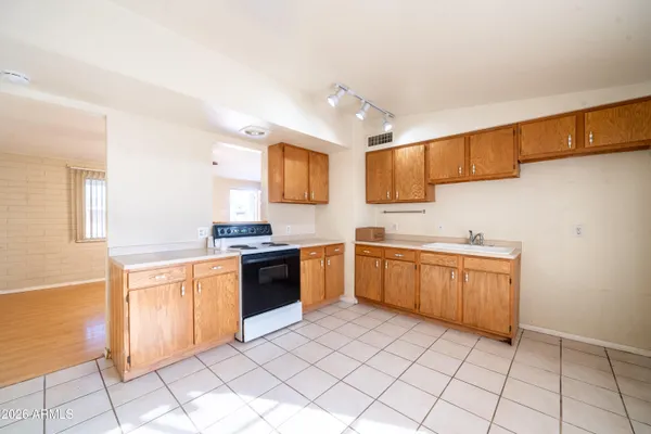 a kitchen with stainless steel appliances granite countertop a sink and a stove top oven