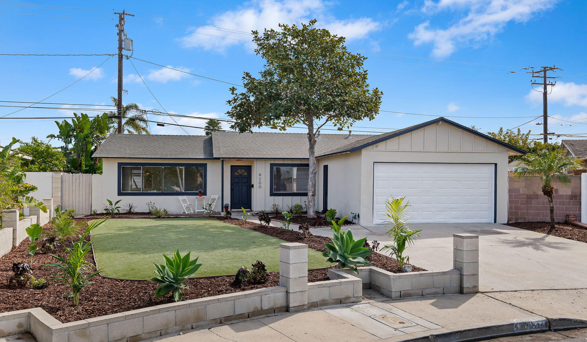 a front view of a house with a garden and patio