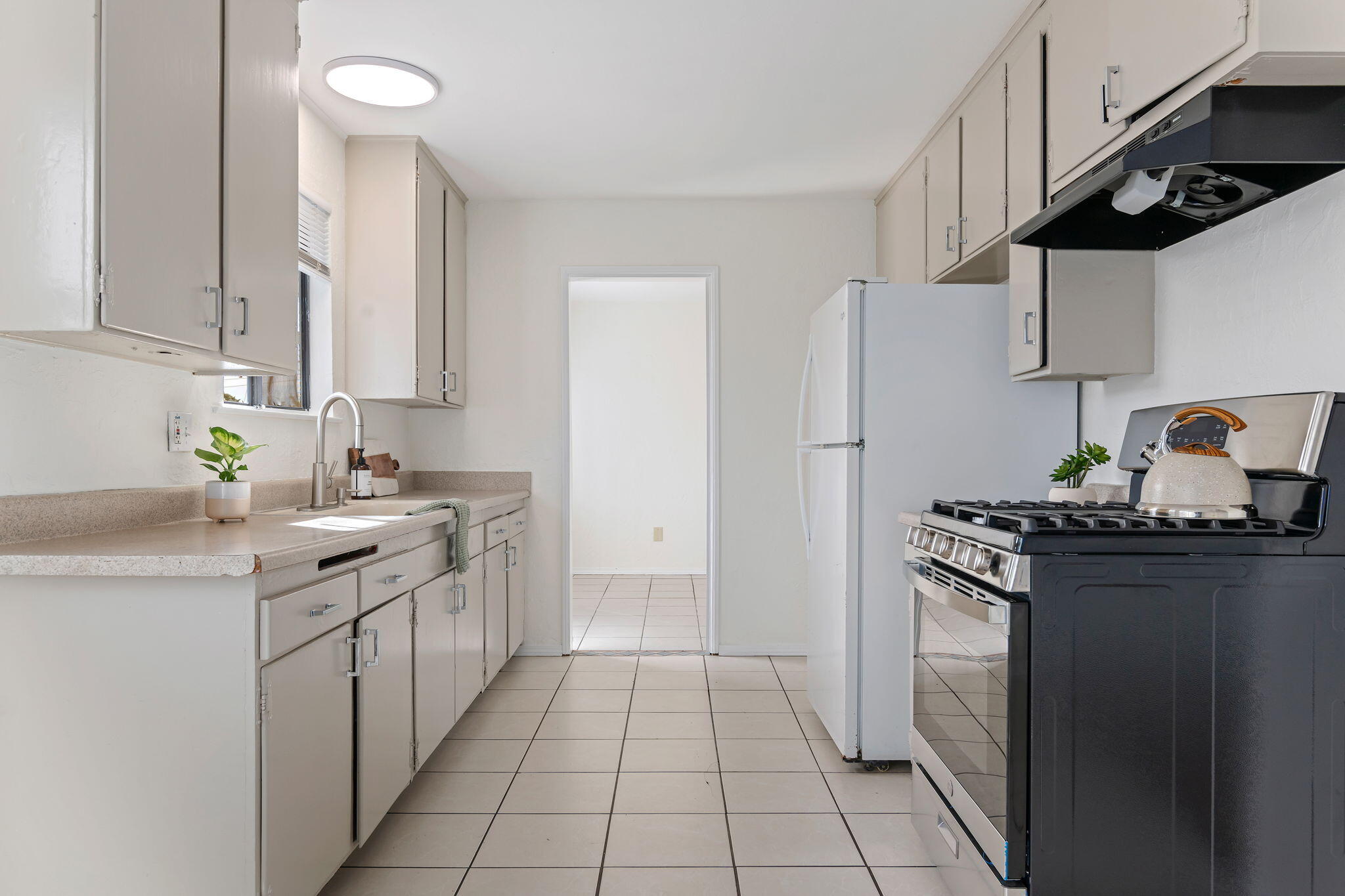 4200 South A Street Oxnard, CA 93033 - Photo 7 of 23 a kitchen with stainless steel appliances a sink stove and refrigerator