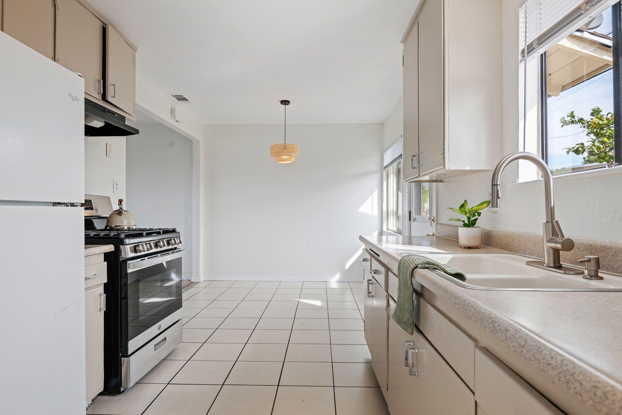 4200 South A Street Oxnard, CA 93033 - Photo 8 of 23 a kitchen with a sink stove and cabinets